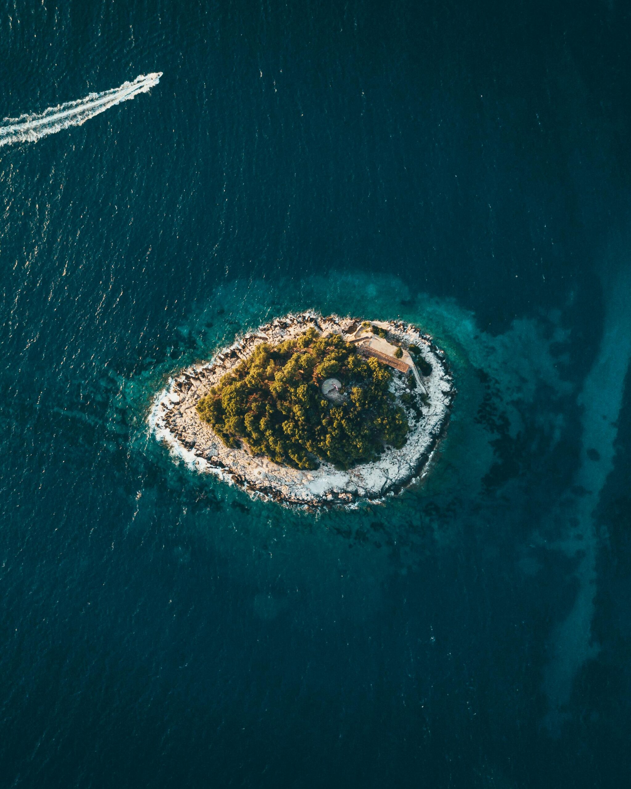 Mice, Destination, Croatia, Unveil the Beauty of the Adriatic Gem, A breathtaking aerial shot of a small lush island surrounded by deep blue ocean waters, captured near Jezerane, Croatia.